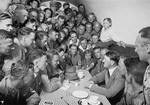 Adolf Hitler speaks to a group of enthralled followers in the basement canteen of the Munich Brown House, a hostel for SA men.