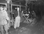 Survivors in a barracks enjoy bowls of soup given to them by the U.S.
