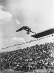 A woman competes in the diving competition at the 11th Summer Olympic Games.
