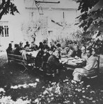 Wehrmacht officers and local Volksdeutsche dine in the garden of a villa in Pancevo, which was seized for the use of Lieutenant Colonel von Bandelow, the city commander.