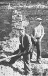 Two Jewish men at forced labor clearing rubble in Konskowola.