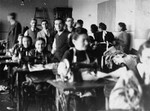 Jewish men and women working in a sewing workshop in the Olkusz ghetto.