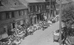 Piles of furniture and household belongings of Jews who are being transferred to the ghetto cover the pavement of a street in Kutno.