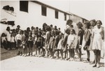Children wait for a meal at the Secours Suisse barracks.