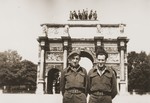 Two Jewish Brigade soldiers pose in front of the Arc de Triomphe du Carrousel in Paris.