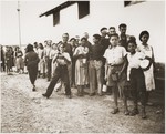 Children wait outside the Secours Suisse barracks for a meal to be served.