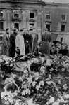 Jewish leaders conduct a ceremony in front of the ruins of the former headquarters of the Warsaw ghetto Jewish council [probably to mark the fourth anniversary of the Warsaw ghetto uprising].