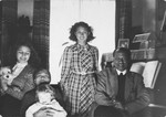 Members of the Madna household pose with the Jewish child they are hiding in their home in The Hague.