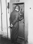 A guard stands outside the prison cell of one of the defendants in the International Military Tribunal trial of war criminals at Nuremberg.