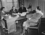 IMT defendant Rudolf Hess speaks to a lawyer or prosecutor in Nuremberg.