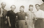 Szmulek Lustiger poses with his wife and her family in the Bedzin ghetto.