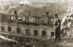 An SS officer surveys the destruction of an apartment house on Zumkowa Street.