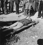 A corpse lies on a stretcher in the Ebensee concentration camp.