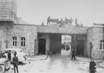 Survivors take down the Nazi eagle that hangs above the entrance to the SS compound in Mauthausen on the day of liberation.