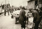 Austrian civilians participate in clearing the dead in the Ebensee concentration camp.