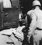 A survivor from the concentration camp at Ebensee is loaded onto an ambulance for transportation to the 139th Evacuation Hospital for medical treatment.