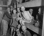Emaciated survivors sit in bunks in one of the infirmary barracks in the Ebensee concentration camp.