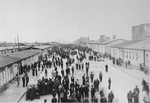 Survivors walk along the main street of the Mauthausen concentration camp.