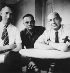 Portrait of three physicians, two of them former concentration camp prisoners, who aided survivors from the Ebensee concentration camp at an American military field hospital.