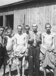 A group of survivors pose in front of a barracks in the newly liberated Ebensee concentration camp.