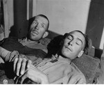 Two survivors rest on a bunk in the infirmary barracks for non-Jewish prisoners in the Ebensee concentration camp.