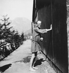 A survivor stands outside the hospital compound in Ebensee.