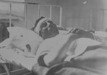 A Jew injured during the pogrom convaleces in a hospital.