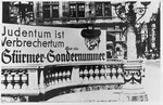 An anti-Semitic "Der Stuermer" advertisement in front of the opera house in Vienna reads: "To be Jewish is to be criminal.