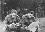 Two Jewish members of the Sixth Labor Battalion (VI Prapor) read outside at a Slovak labor camp.