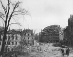 View of destroyed buildings on a city street in Germany at the end of World War II.