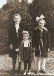 A Jewish child in hiding (center) poses with the daughters of her Polish rescuer, Genowefa Starczewska-Korczak.