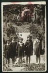 Five school girls pose in a garden in Eisiskes.  

Standing at the far right is Altke Koutsai.