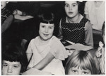 Close up of a several young students at their desks.