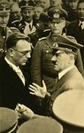 Hitler in conversation with Artur Seyss-Inquart (left) at an official ceremony.