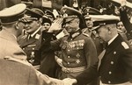 Hitler greets German military leaders at an official ceremony.