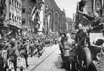 Baldur von Schirach (saluting), leader of the Hitler Youth, and Julius Streicher (in light-colored jacket), editor of the antisemitic newspaper, "Der Stuermer," review a parade of Hitler Youth in Nuremberg.
