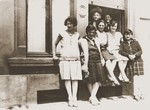 A group of young Jewish men and women pose outside on a street in Luxembourg.