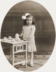 Studio portrait of Johanna Meijer playing with a tea set.