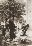 Wearing a formal jacket and top hat, Louis Meijer places a wreath at the monument for local victims of the Second World War during a memorial ceremony in Boekelo.