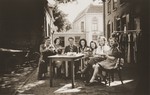 Bep Menco (center) and co-workers at the Zion store enjoy a coffee break in the courtyard behind the business.
