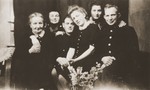 Two Jewish women, who were hidden by the Leuverink family during the war, pose with their rescuers on the occasion of the engagement of their children, Zus and Gerbrandt Leuverink.