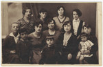 Studio portrait of an extended prewar Jewish family in Poland taken at a wedding.