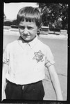 Portrait of a Jewish child wearing a Star of David.