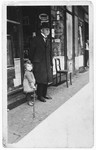 Hannelore Mansbacher with her grandfather Samuel Moses (mother's father) in front of her parents' grocery store.