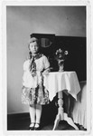 Hannelore Mansbacher poses in her home in a Purim peasant costume.