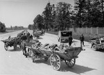 Carts laden with corpses leave the Dachau concentration camp on route to a burial site.