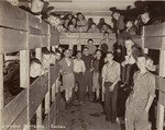 Survivors in a crowded Dachau barrack after liberation.