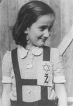 Portrait of a young girl in the Loborgrod concentration camp wearing a Jewish badge.