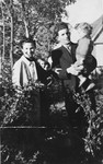 Bernard and Cesia Kaiser pose outside with their son, Jurek, in Chlewice after fleeing from the Kielce ghetto.