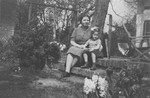 Dutch rescuer Wilhelmina Salters-Kloppenburg, sits on the steps outside her home with Elizabeth Reiss, a Jewish child she is hiding,